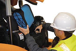 A service worker working on Case heavy equipment