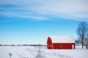 Red barn covered in snow